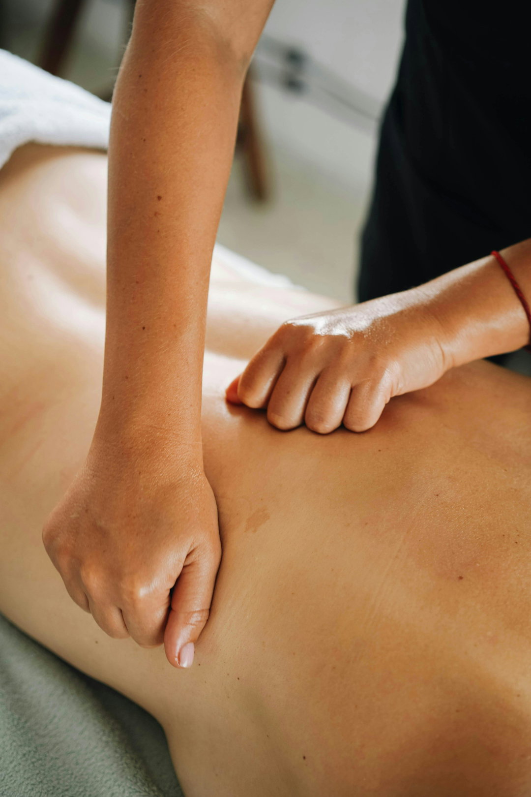 a-massage-therapist-provides-a-back-massage-.jpg A massage therapist provides a back massage.