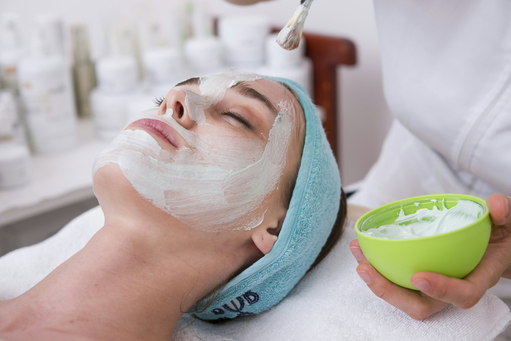 woman-lying-on-blue-towel-with-white-cream-on-face.jpg woman lying on blue towel with white cream on face